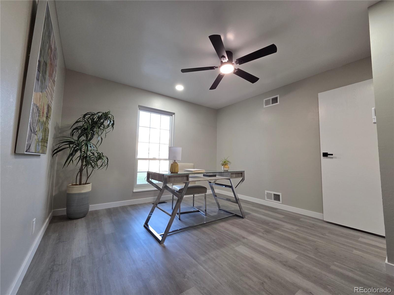 1250 South Monaco Parkway, Unit 17 Denver, CO 80224 - Photo 20 of 29 a workspace with wooden floor and windows