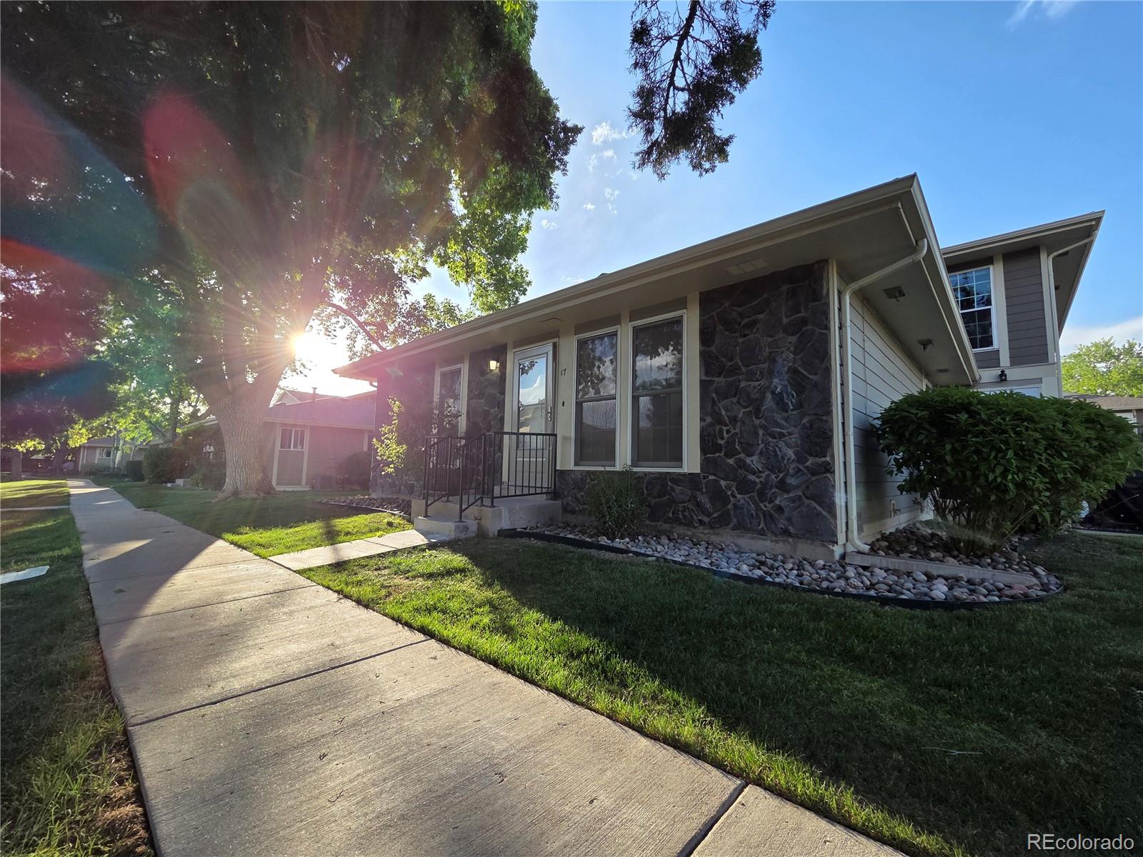 1250 South Monaco Parkway, Unit 17 Denver, CO 80224 - Photo 22 of 29 a front view of a house with a yard