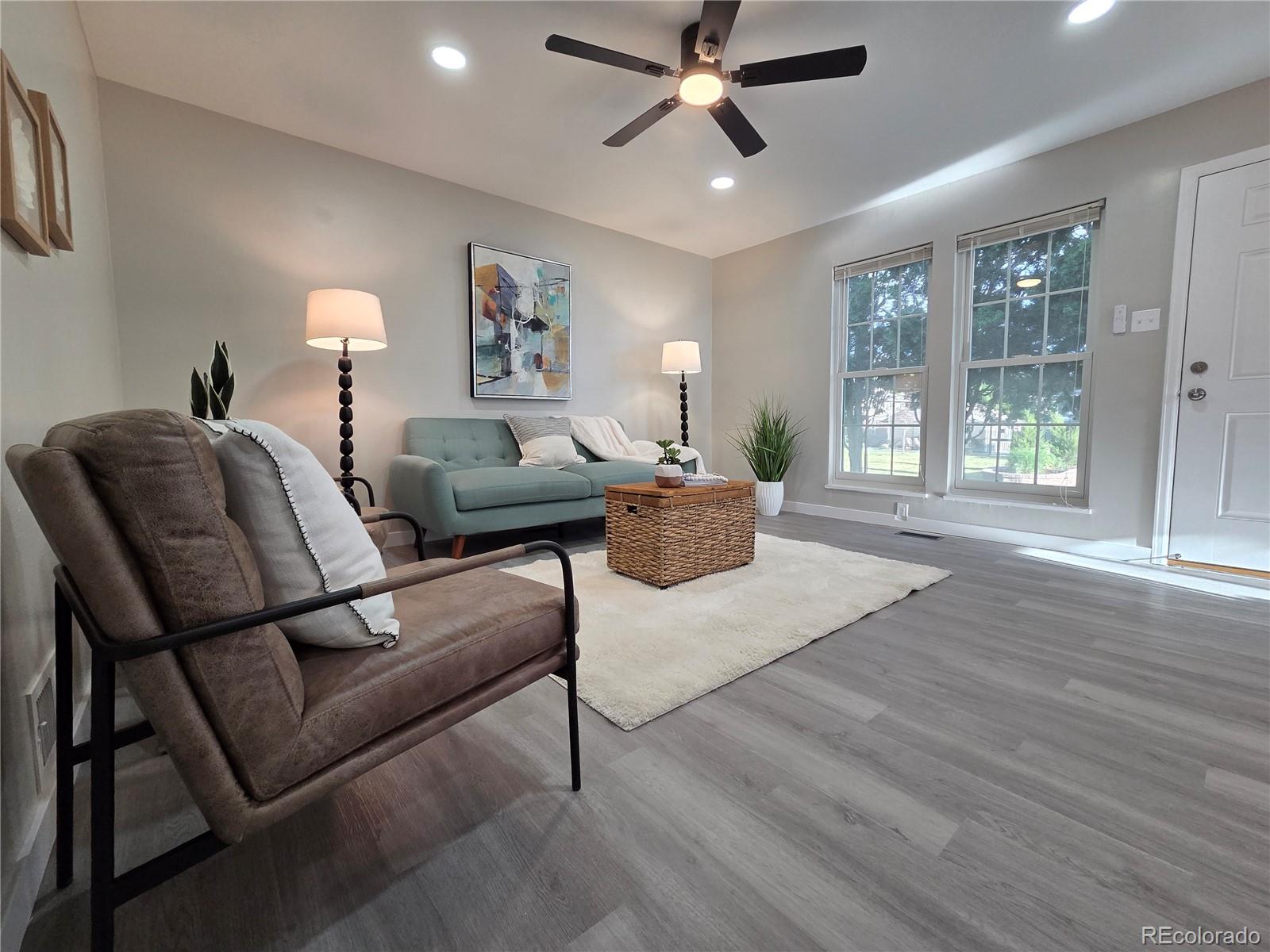 1250 South Monaco Parkway, Unit 17 Denver, CO 80224 - Photo 3 of 29 a living room with furniture and a large window