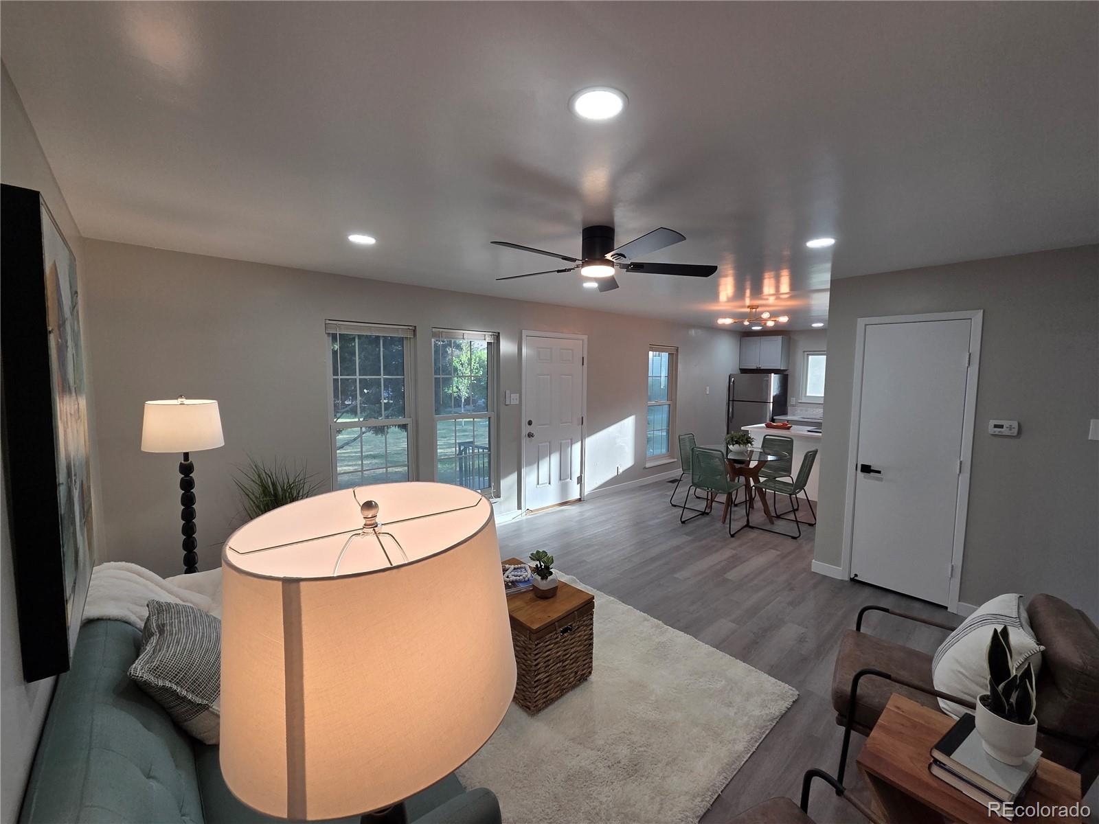 1250 South Monaco Parkway, Unit 17 Denver, CO 80224 - Photo 4 of 29 a room with furniture and a chandelier