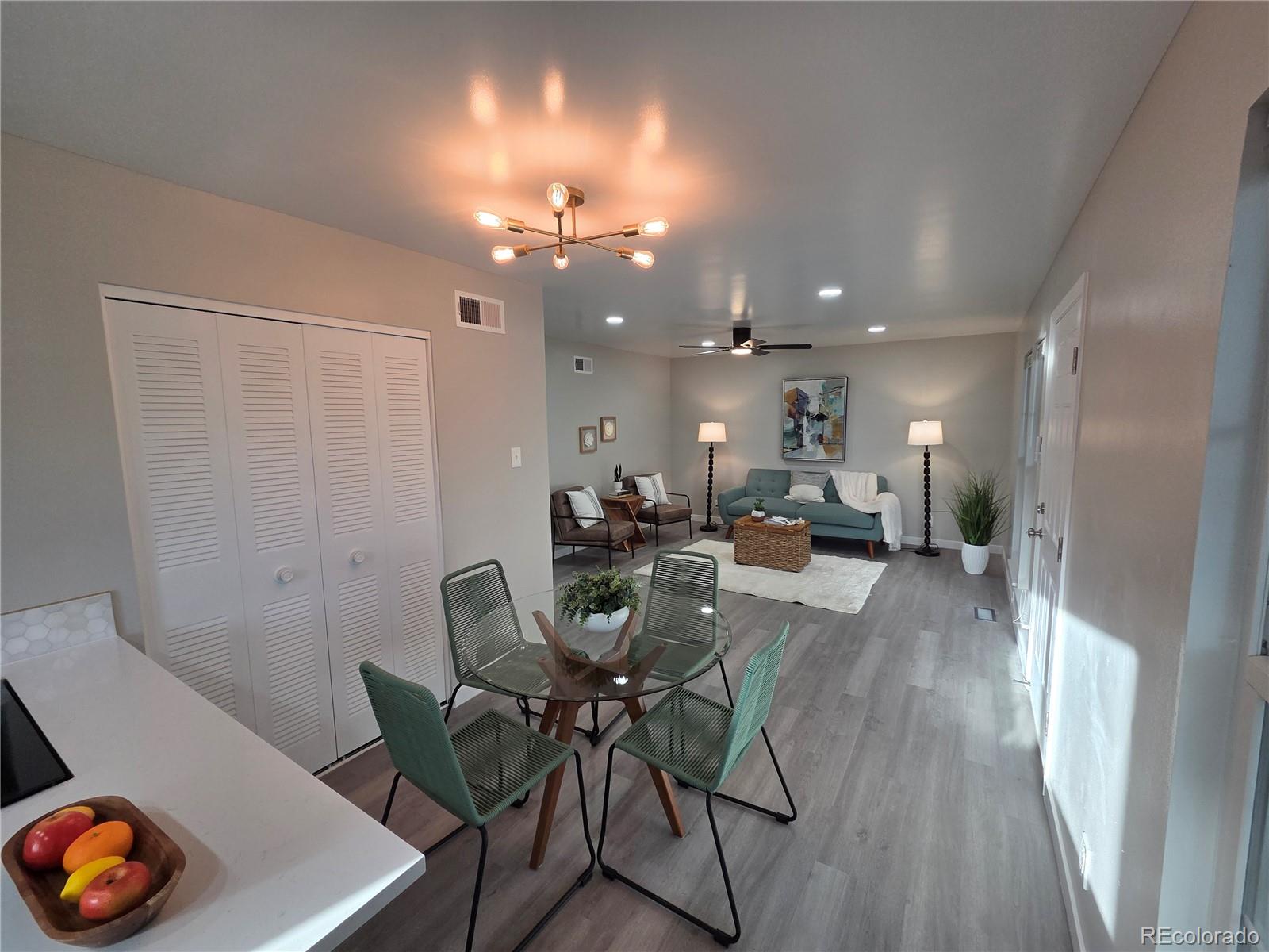 1250 South Monaco Parkway, Unit 17 Denver, CO 80224 - Photo 5 of 29 a view of a dining room with furniture and wooden floor