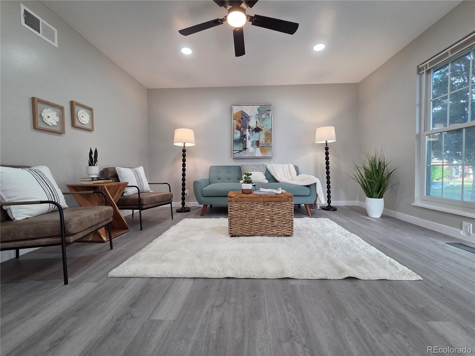 1250 South Monaco Parkway, Unit 17 Denver, CO 80224 - Photo 6 of 29 a living room with furniture and a large window