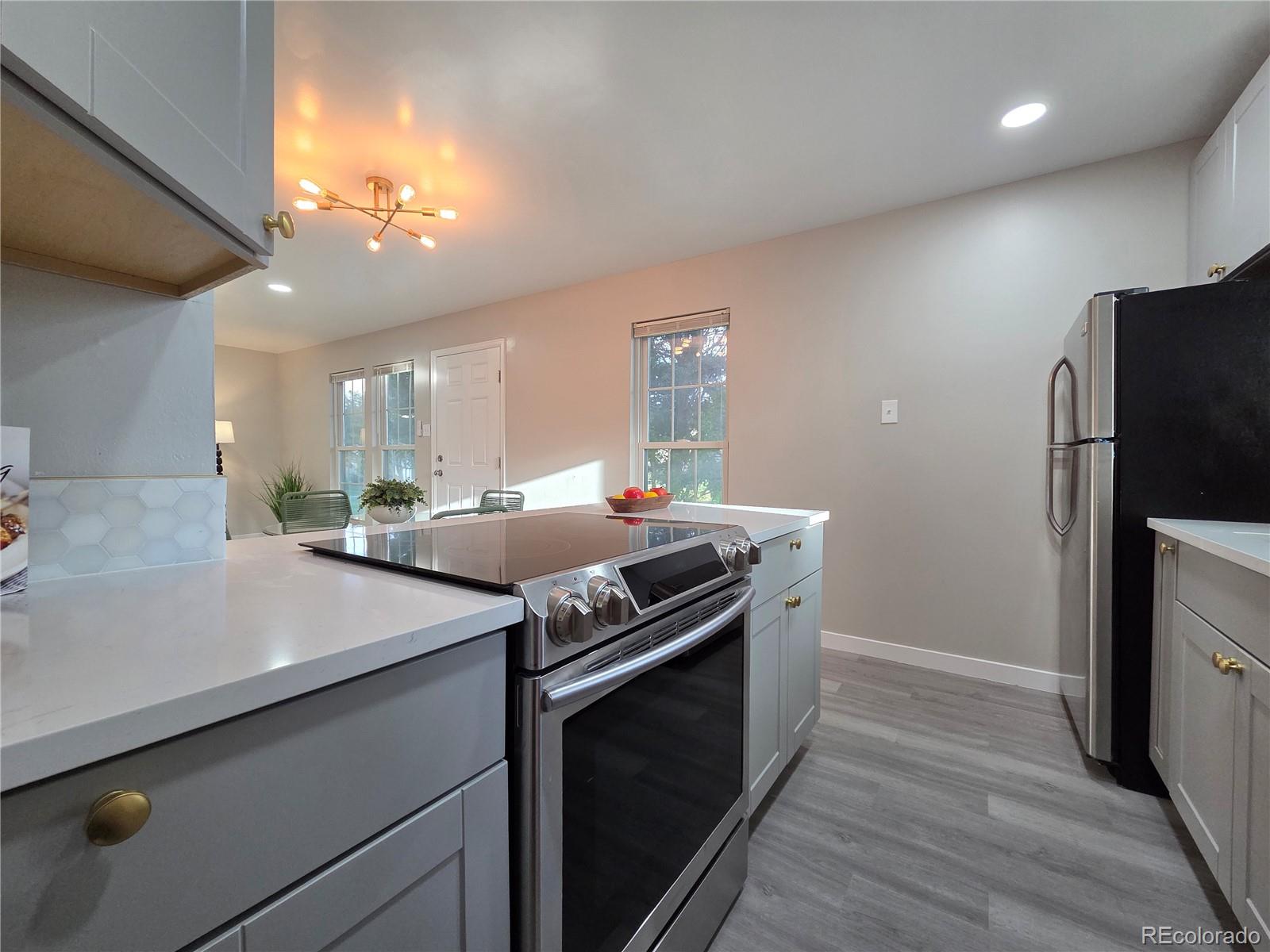 1250 South Monaco Parkway, Unit 17 Denver, CO 80224 - Photo 10 of 29 a kitchen with a stove and a refrigerator