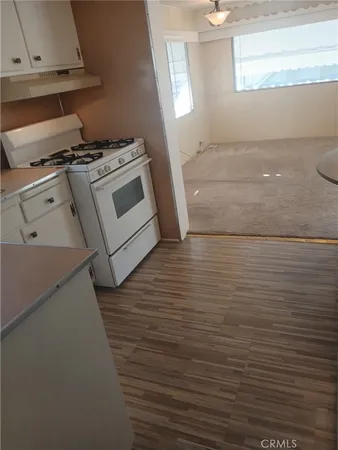 a stove top oven sitting inside of a kitchen