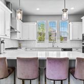 a kitchen with stainless steel appliances granite countertop a sink window and a refrigerator