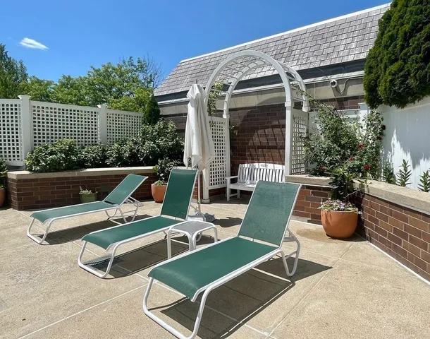 a building outdoor space with patio furniture and potted plants
