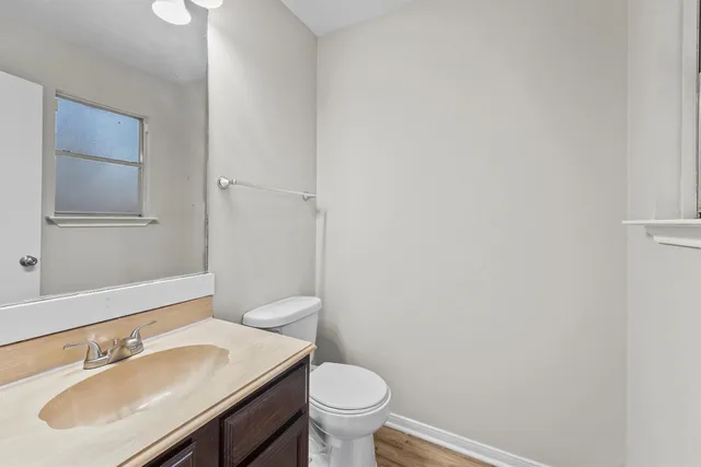 a bathroom with a sink toilet and a mirror