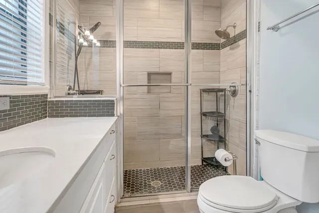 a bathroom with a sink toilet and shower