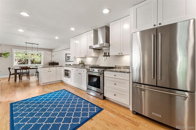 a kitchen with stainless steel appliances granite countertop a refrigerator sink and cabinets