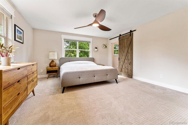 a spacious bedroom with a bed and a chandelier
