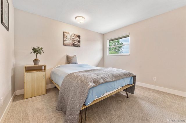 a bedroom with a bed and a table