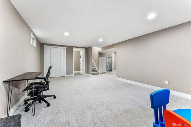 a room with gym equipment and a rug