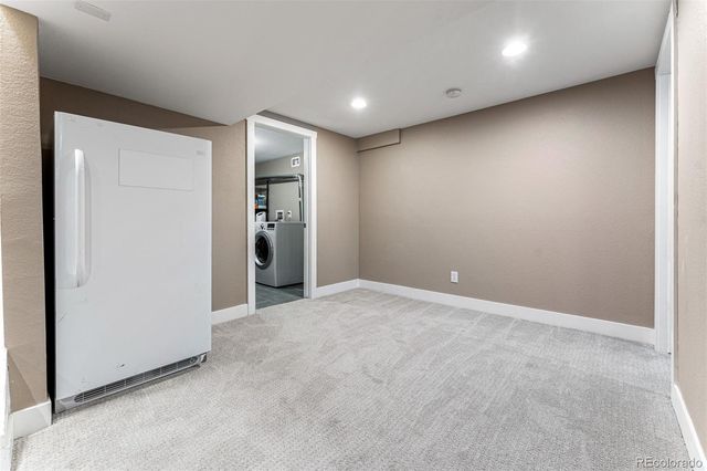 an empty room with closet and a window