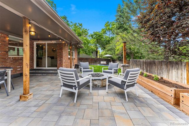 a view of a patio with a table and chairs