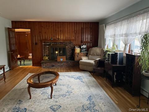 8 Atlantic Avenue Blue Point, NY 11715 - Photo 15 of 24 a living room with furniture a fireplace and a table