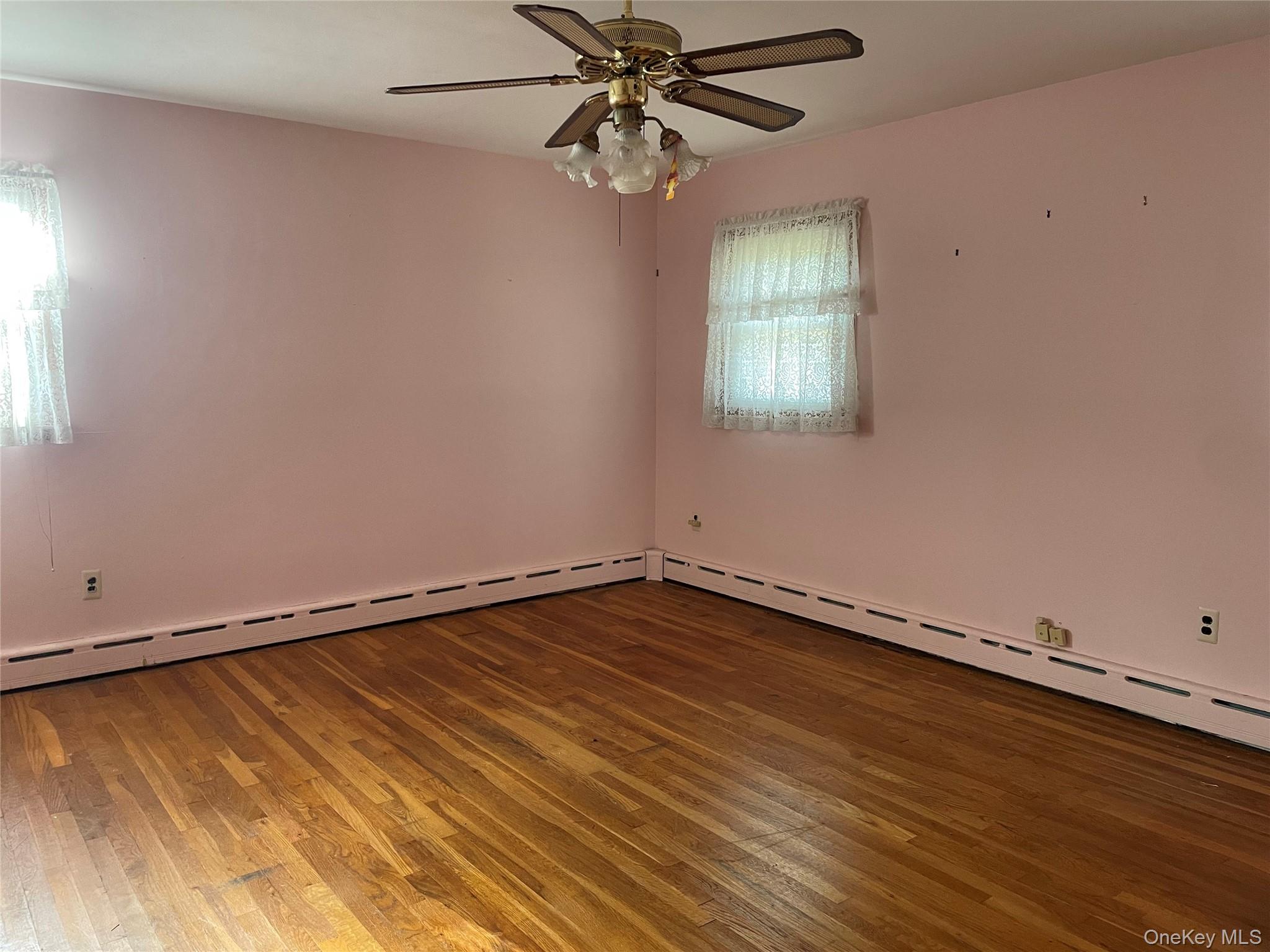 8 Atlantic Avenue Blue Point, NY 11715 - Photo 17 of 24 wooden floor in an empty room with a window