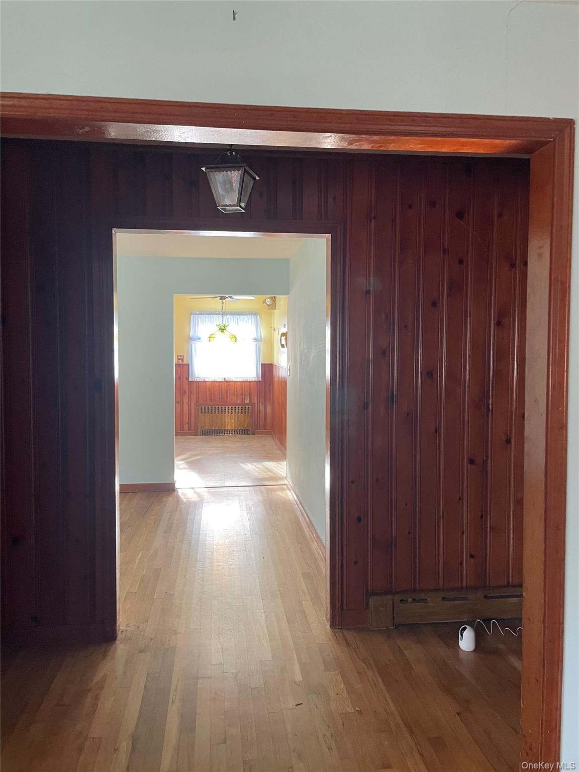 8 Atlantic Avenue Blue Point, NY 11715 - Photo 22 of 24 a view of a hallway with wooden floor and a living room