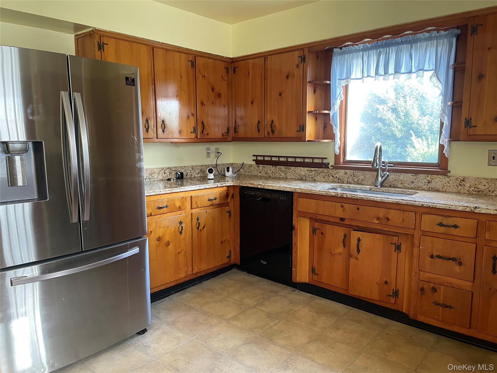 8 Atlantic Avenue Blue Point, NY 11715 - Photo 10 of 24 a kitchen with stainless steel appliances granite countertop a refrigerator sink and cabinets