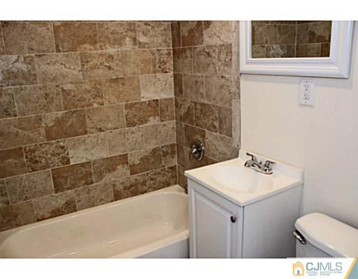 202 Jackson Avenue Edison, NJ 08837 - Photo 13 of 17 a bathroom with a sink toilet and mirror