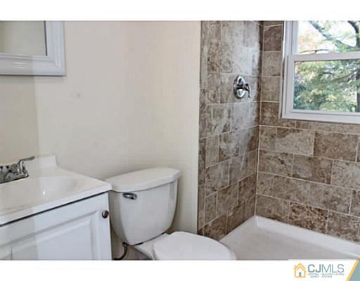 202 Jackson Avenue Edison, NJ 08837 - Photo 16 of 17 a bathroom with a sink toilet and shower