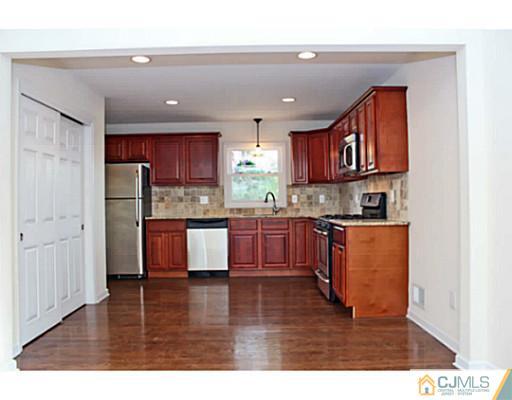 202 Jackson Avenue Edison, NJ 08837 - Photo 4 of 17 a kitchen with stainless steel appliances granite countertop a refrigerator sink and cabinets