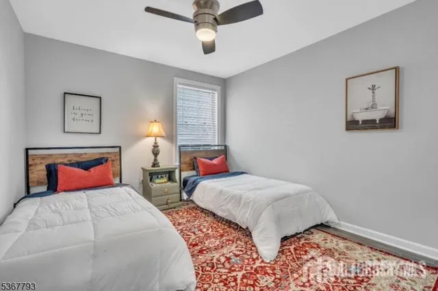a bedroom with two beds and a chandelier