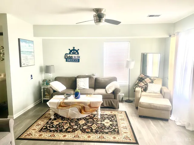 a living room with furniture and a rug