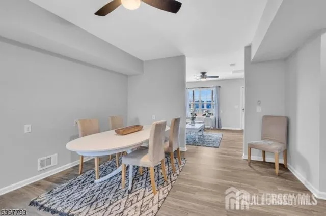 a view of a livingroom with furniture and a dining table