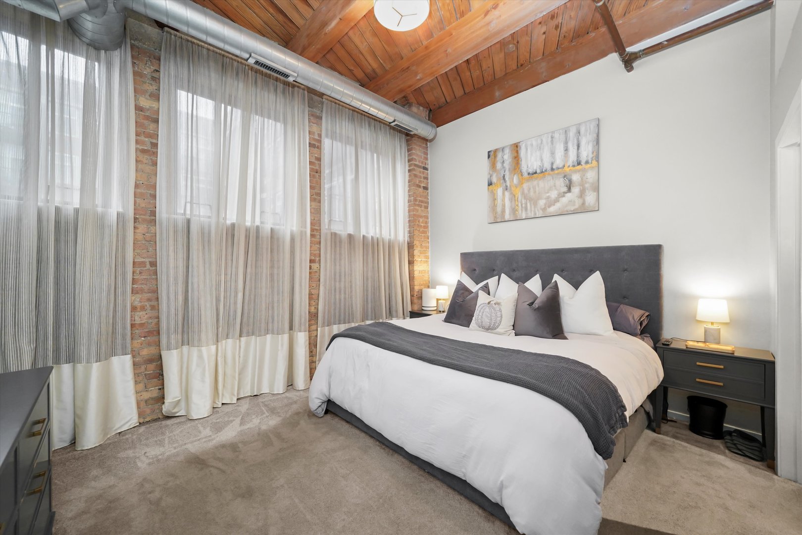 Undisclosed Address Chicago, IL 60607 - Photo 12 of 34 a large bed sitting in a bedroom next to a window