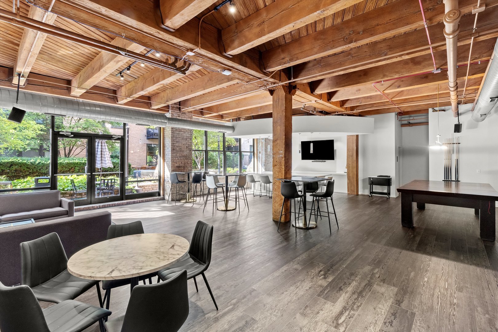 Undisclosed Address Chicago, IL 60607 - Photo 21 of 34 a dining room with wooden floor a glass table and chairs