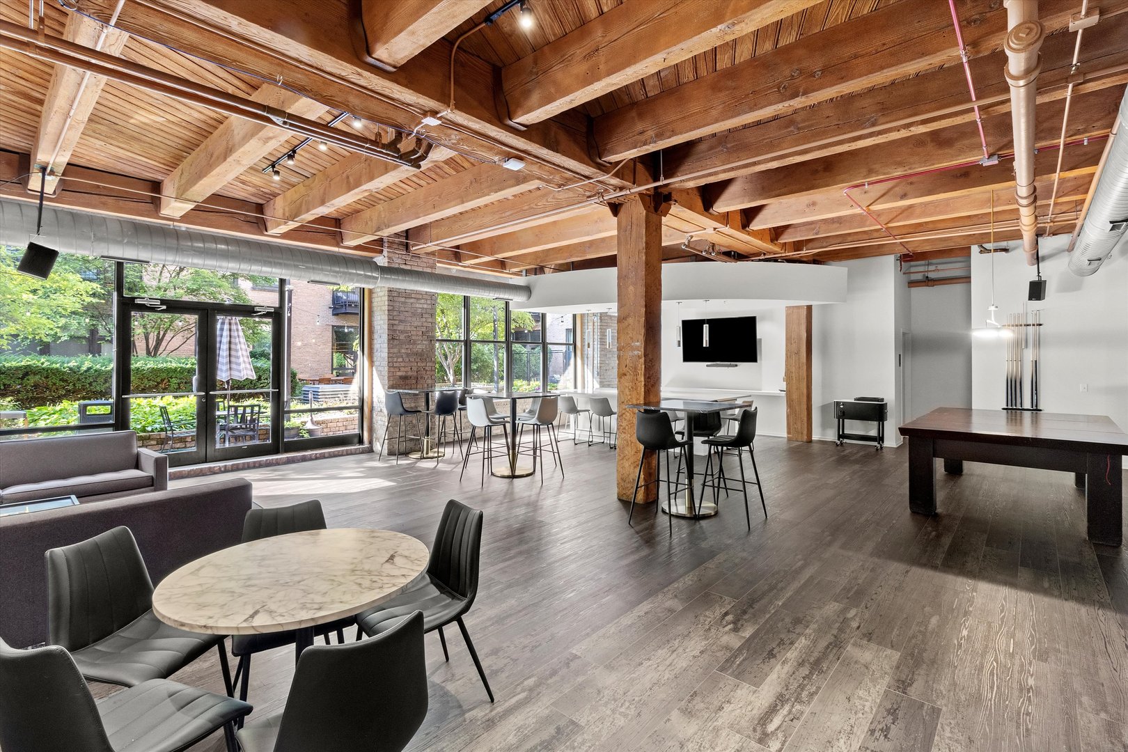 Undisclosed Address Chicago, IL 60607 - Photo 25 of 34 a dining room with wooden floor a glass table and chairs
