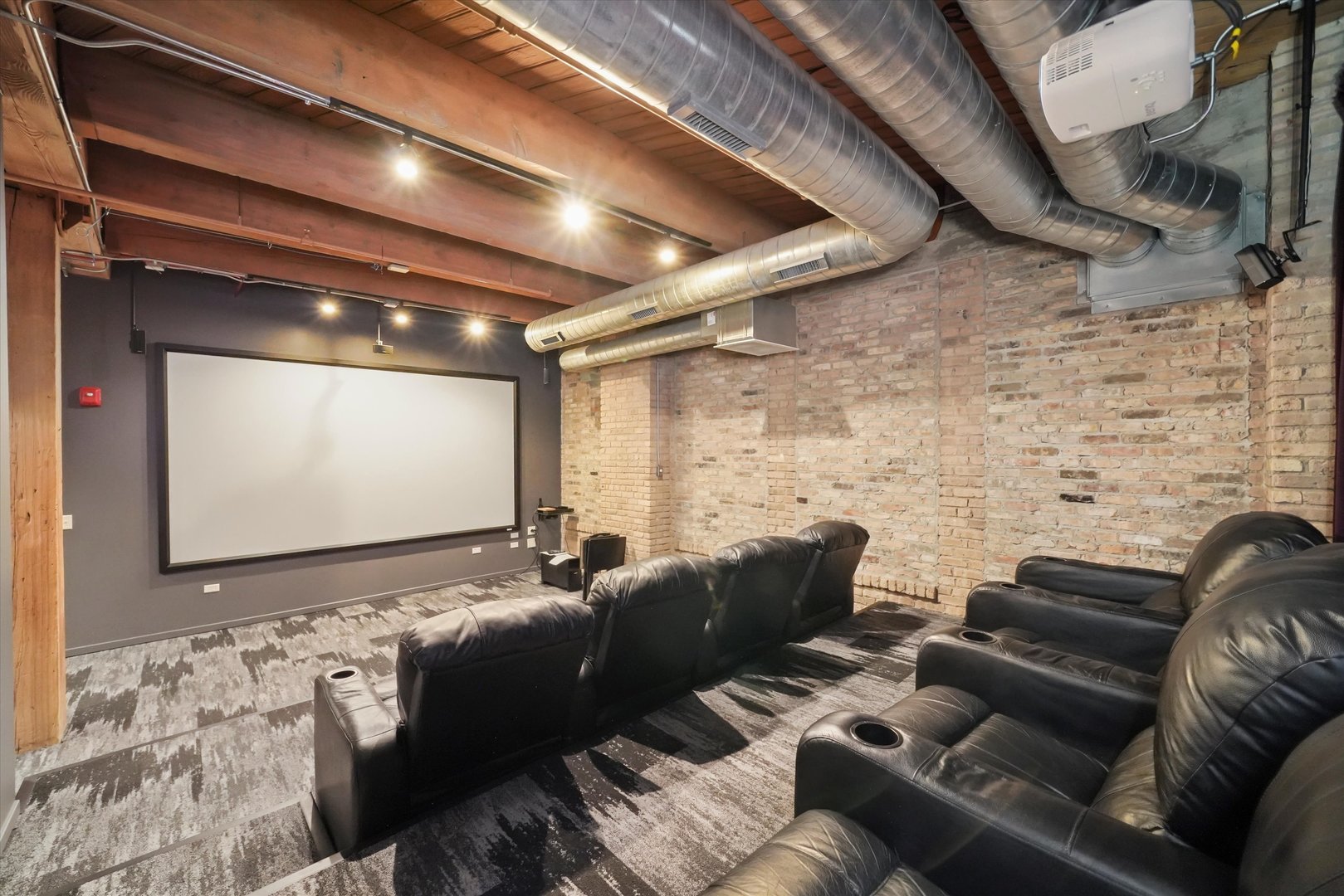 Undisclosed Address Chicago, IL 60607 - Photo 26 of 34 a media room with lots of chairs and a projector screen