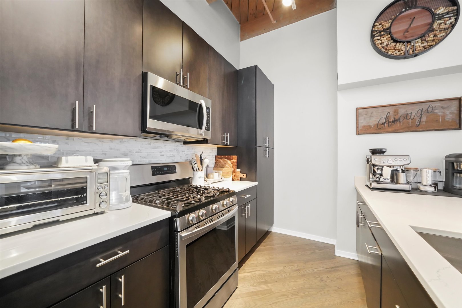 Undisclosed Address Chicago, IL 60607 - Photo 9 of 34 a kitchen with stainless steel appliances granite countertop a stove microwave and sink