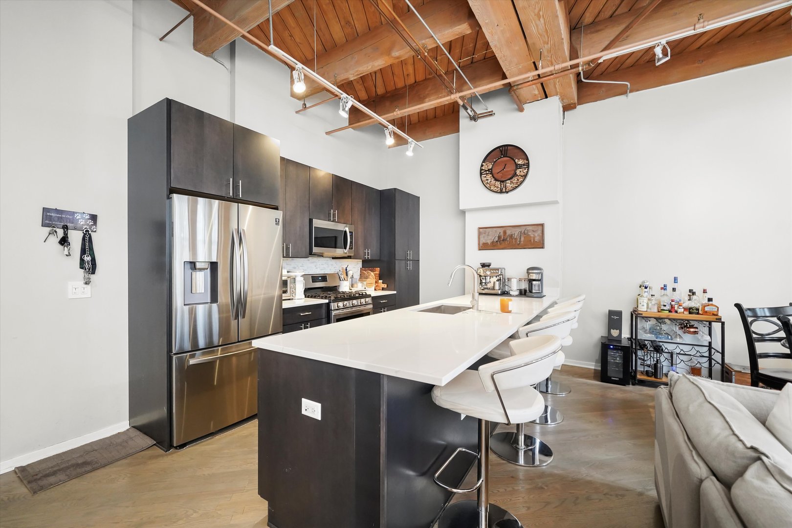 Undisclosed Address Chicago, IL 60607 - Photo 10 of 34 a kitchen with stainless steel appliances granite countertop a dining table chairs refrigerator and sink