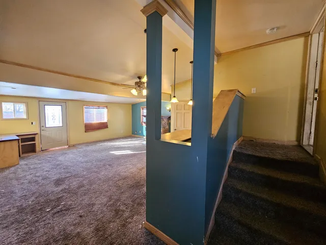 a view of an empty room with large windows