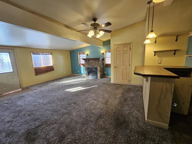a view of kitchen and chandelier fan