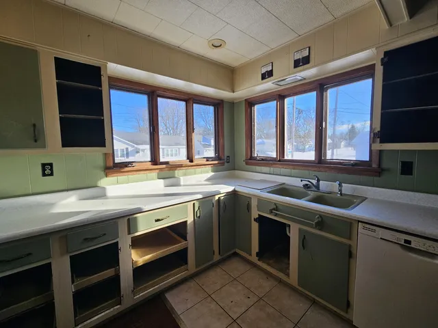 a kitchen with a sink stove and cabinets