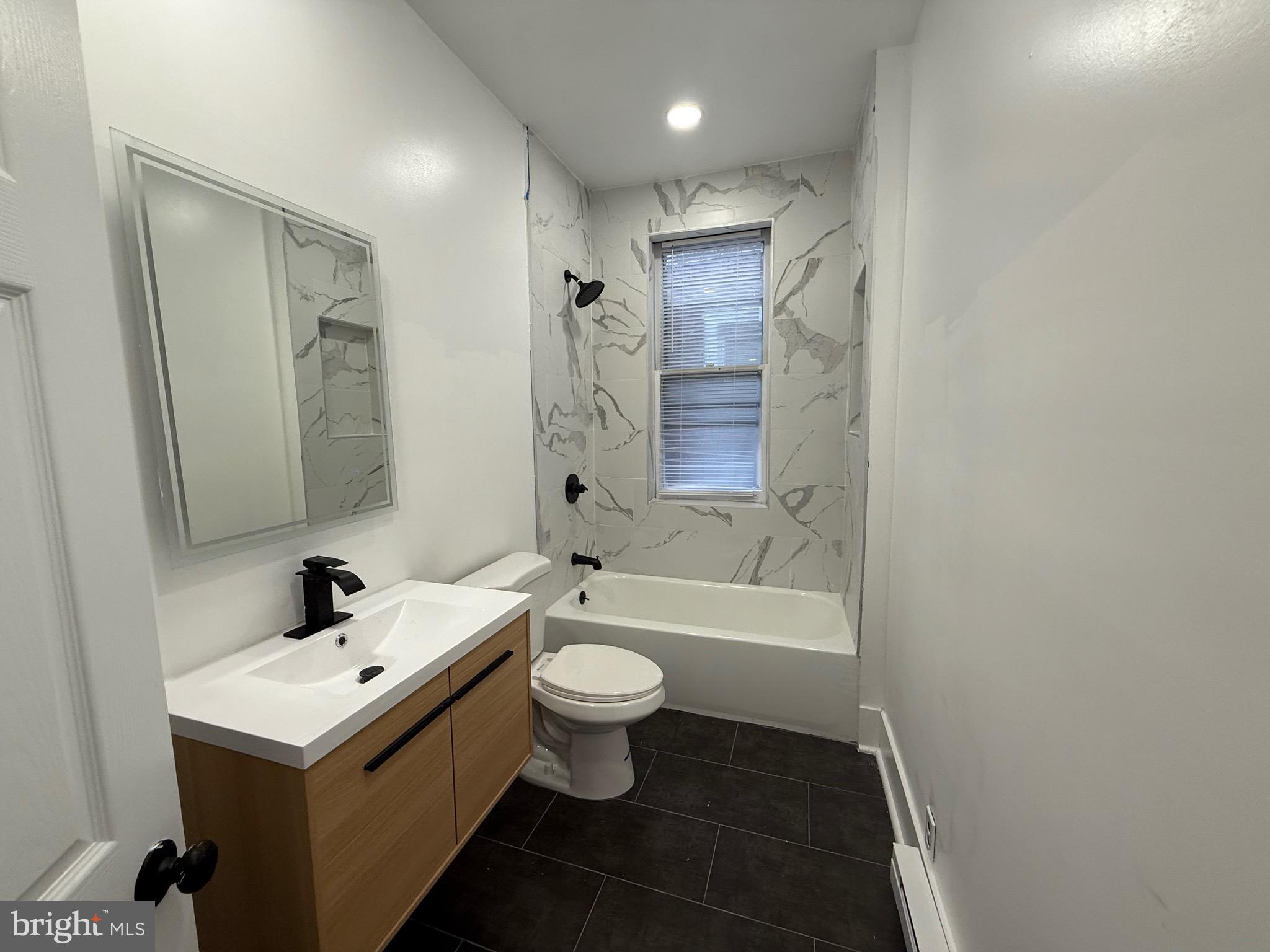 114 South 58th Street, Unit 2 Philadelphia, PA 19139 - Photo 4 of 10 a bathroom with a sink a toilet and shower