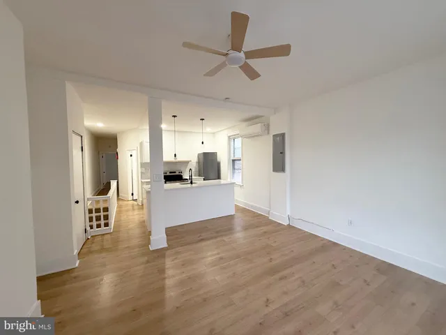 a view of a kitchen with a sink and a refrigerator