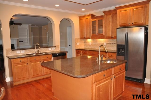 Spacious kitchen: stainless sink overlooks breakfast bar and family room; big center island offers lots of preparation space and veggie sink; hardwood floors; a plethora of cabinets Kitchen