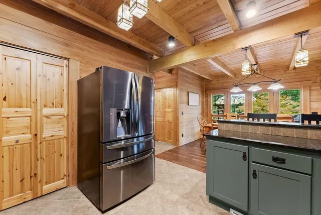 a kitchen with stainless steel appliances kitchen island granite countertop a stove and cabinets