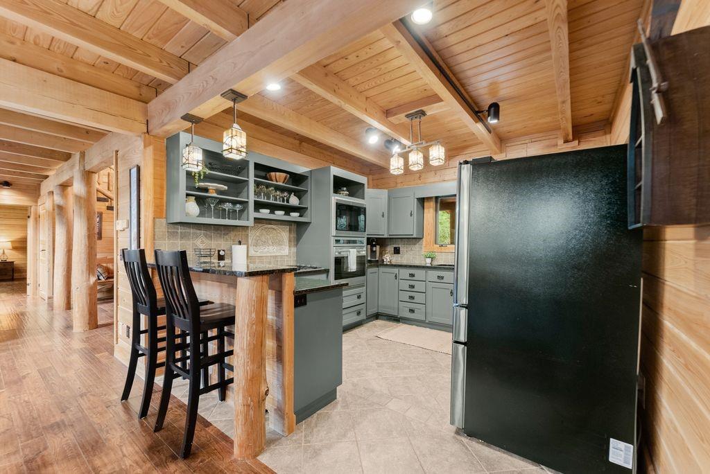 994 Whispering Hill Drive Cherry Log, GA 30522 - Photo 22 of 74 a kitchen with stainless steel appliances kitchen island granite countertop a table chairs and a refrigerator