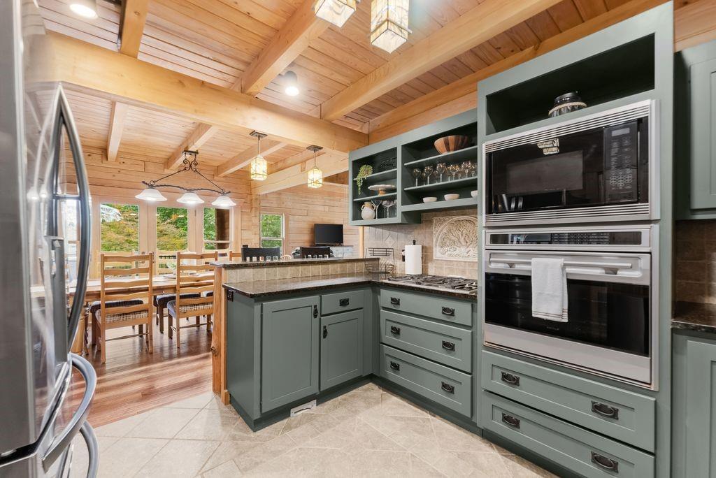 994 Whispering Hill Drive Cherry Log, GA 30522 - Photo 23 of 74 a kitchen with stainless steel appliances kitchen island granite countertop a stove and cabinets