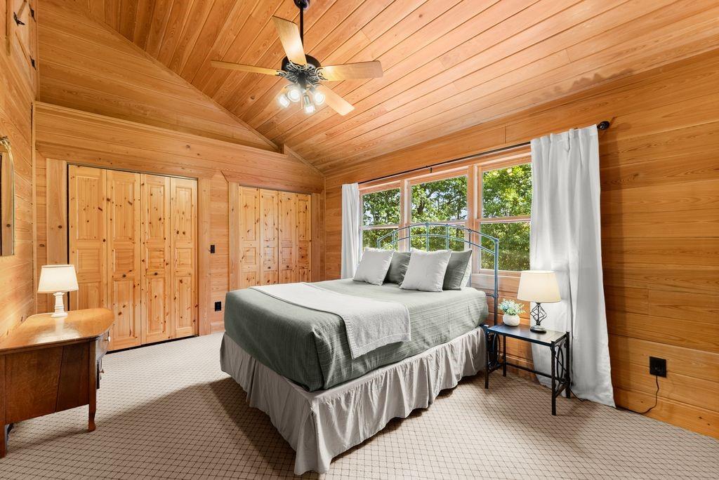 994 Whispering Hill Drive Cherry Log, GA 30522 - Photo 48 of 74 a bedroom with a large bed and a chandelier