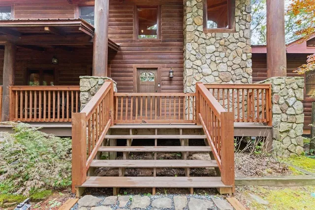 a view of a house with a yard and sitting area