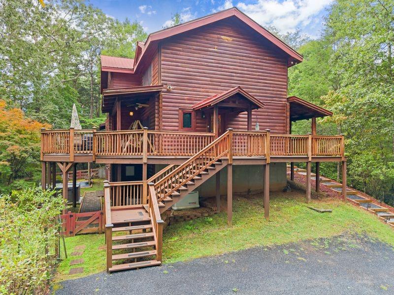 994 Whispering Hill Drive Cherry Log, GA 30522 - Photo 8 of 74 a front view of a house with a yard table and chairs