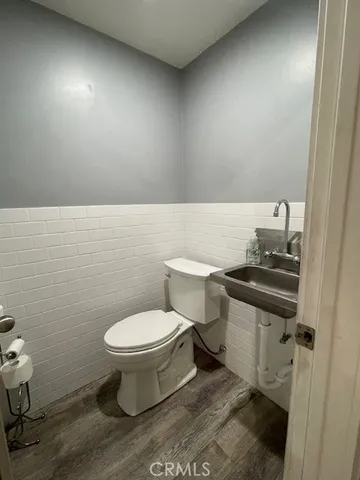 a bathroom with a toilet a sink and a mirror