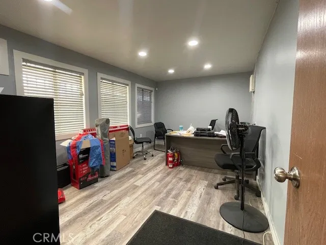 a view of a workspace with furniture and a window