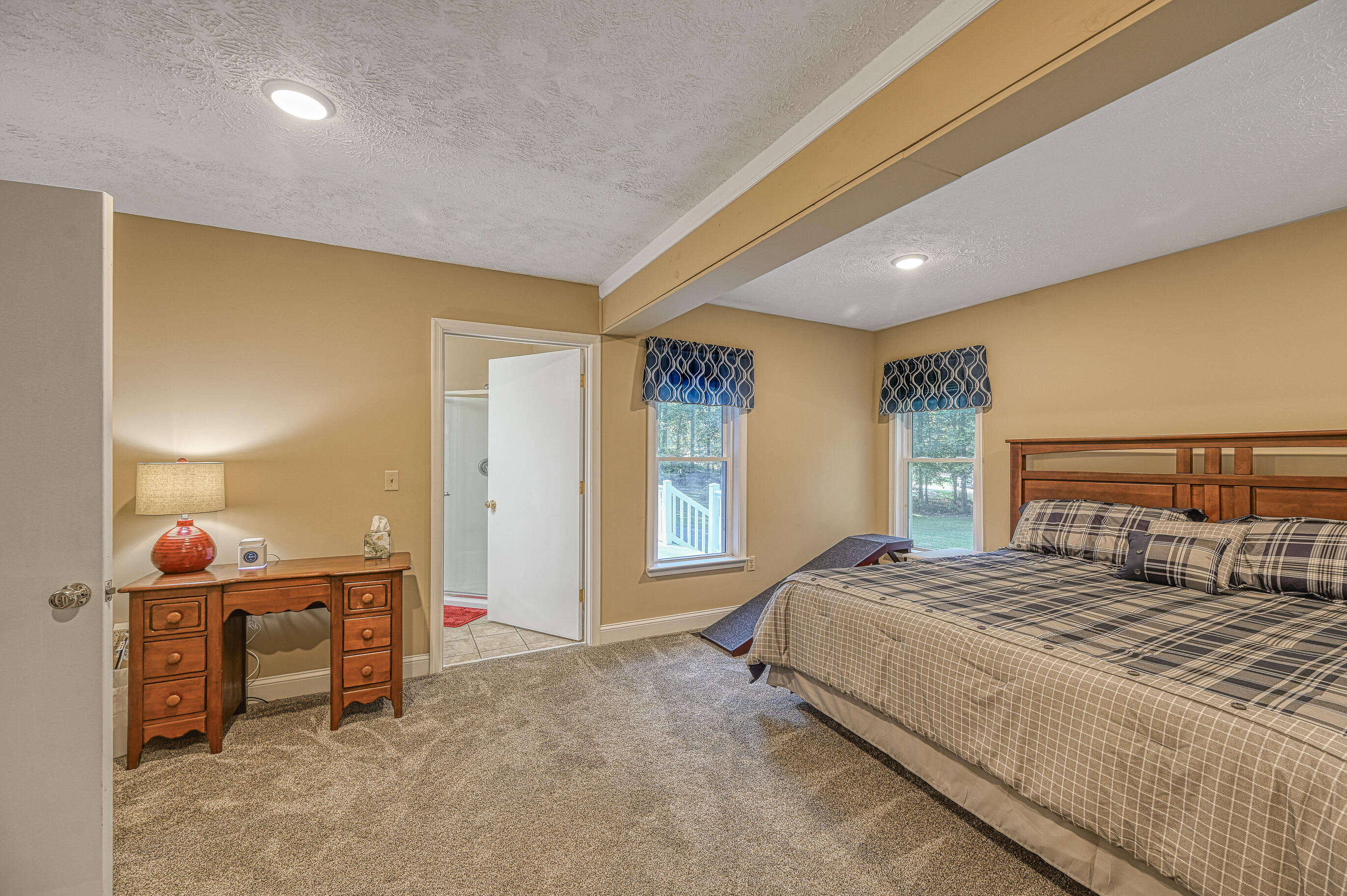 206 Oak Road Bumpass, VA 23024 - Photo 15 of 38 a bedroom with a bed and dresser with mirror