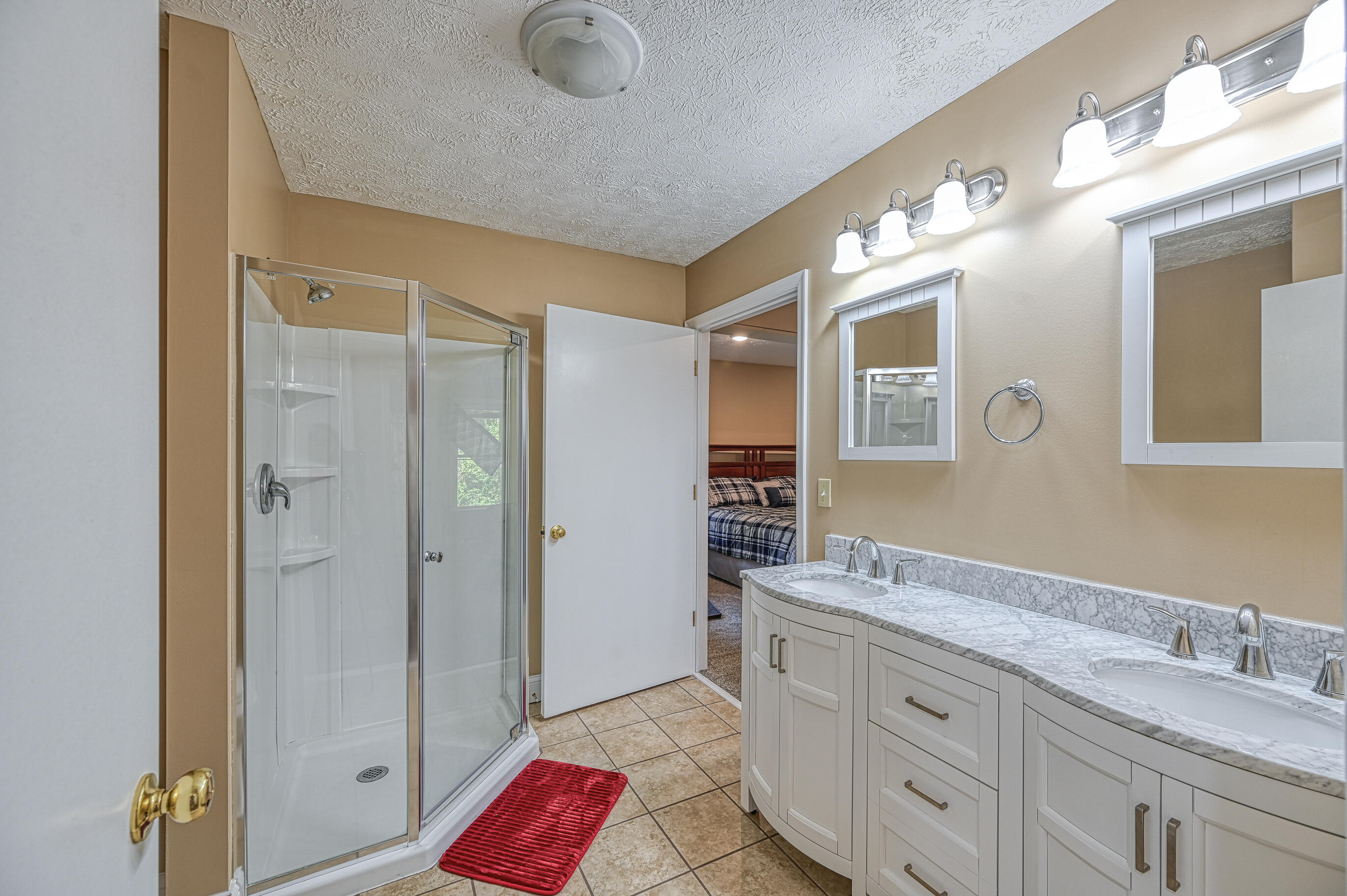 206 Oak Road Bumpass, VA 23024 - Photo 17 of 38 a spacious bathroom with a granite countertop sink mirror and shower